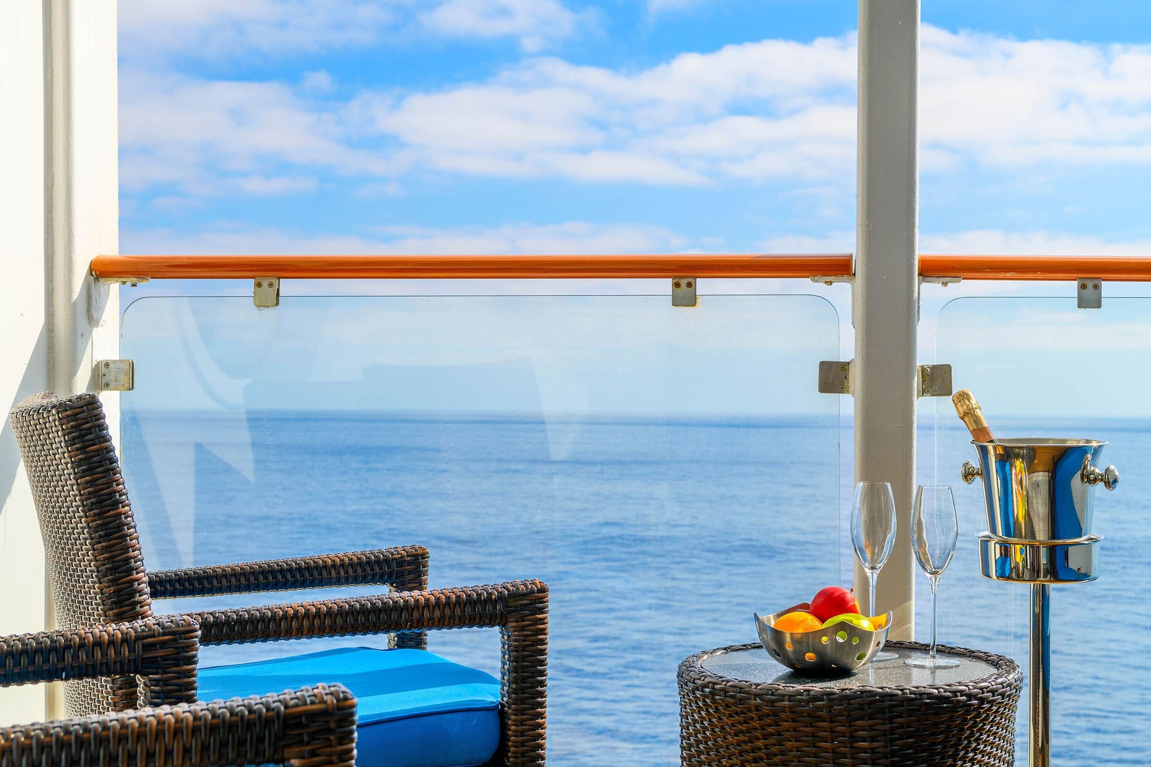 Modern hotel room with balcony overlooking a stunning turquoise ocean.